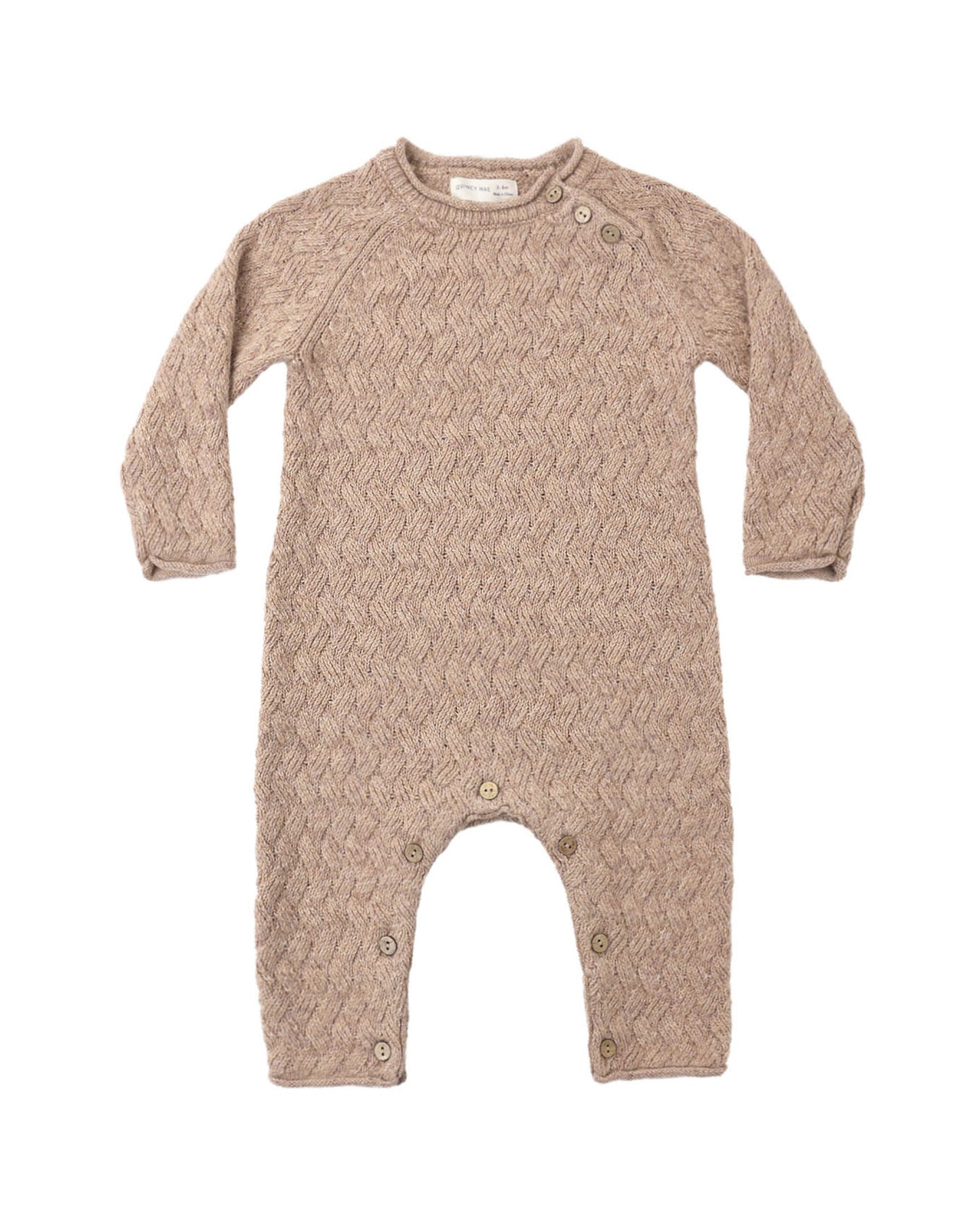 Knit baby jumpsuit in almond color on a white background
