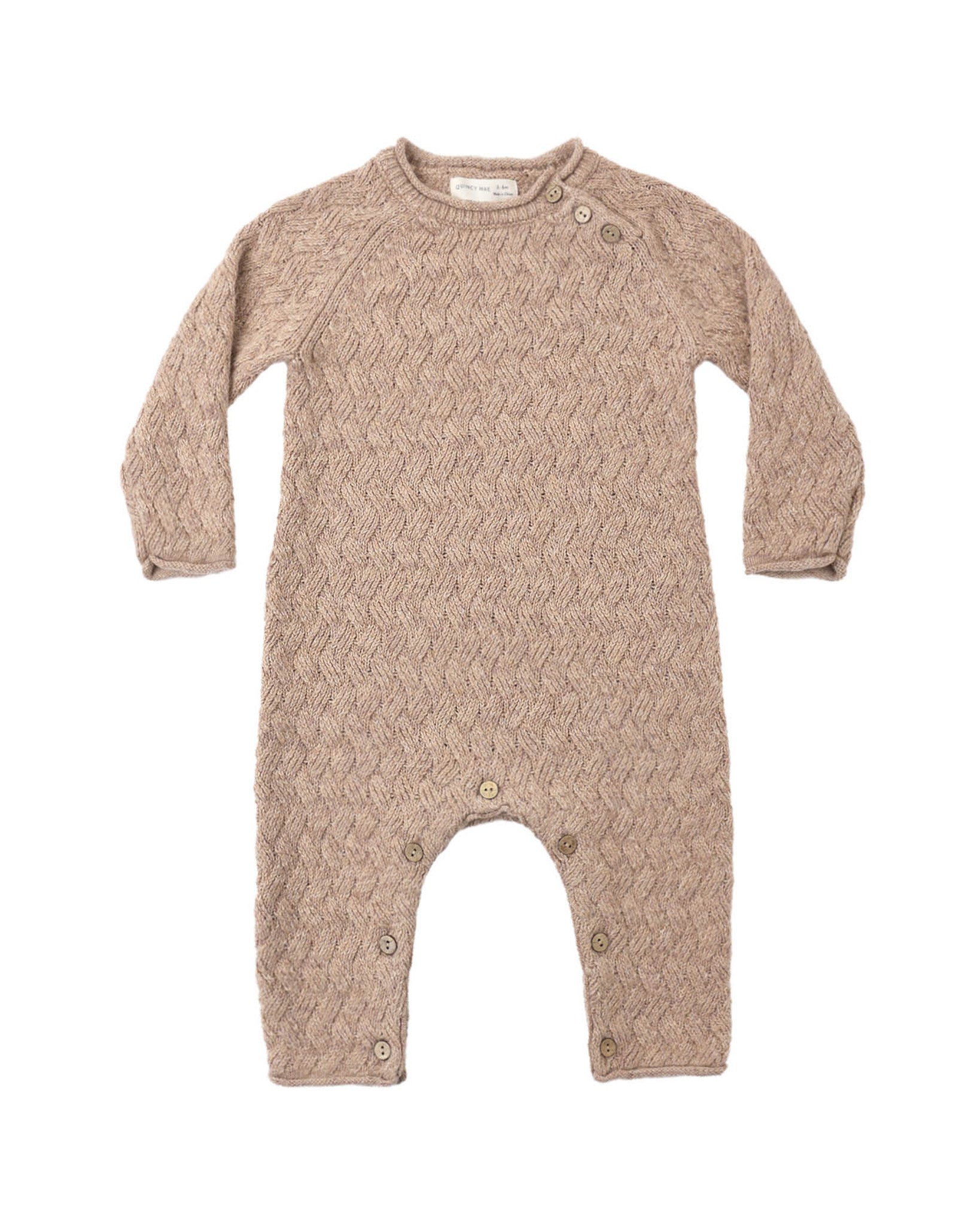 Knit baby jumpsuit in almond color on a white background