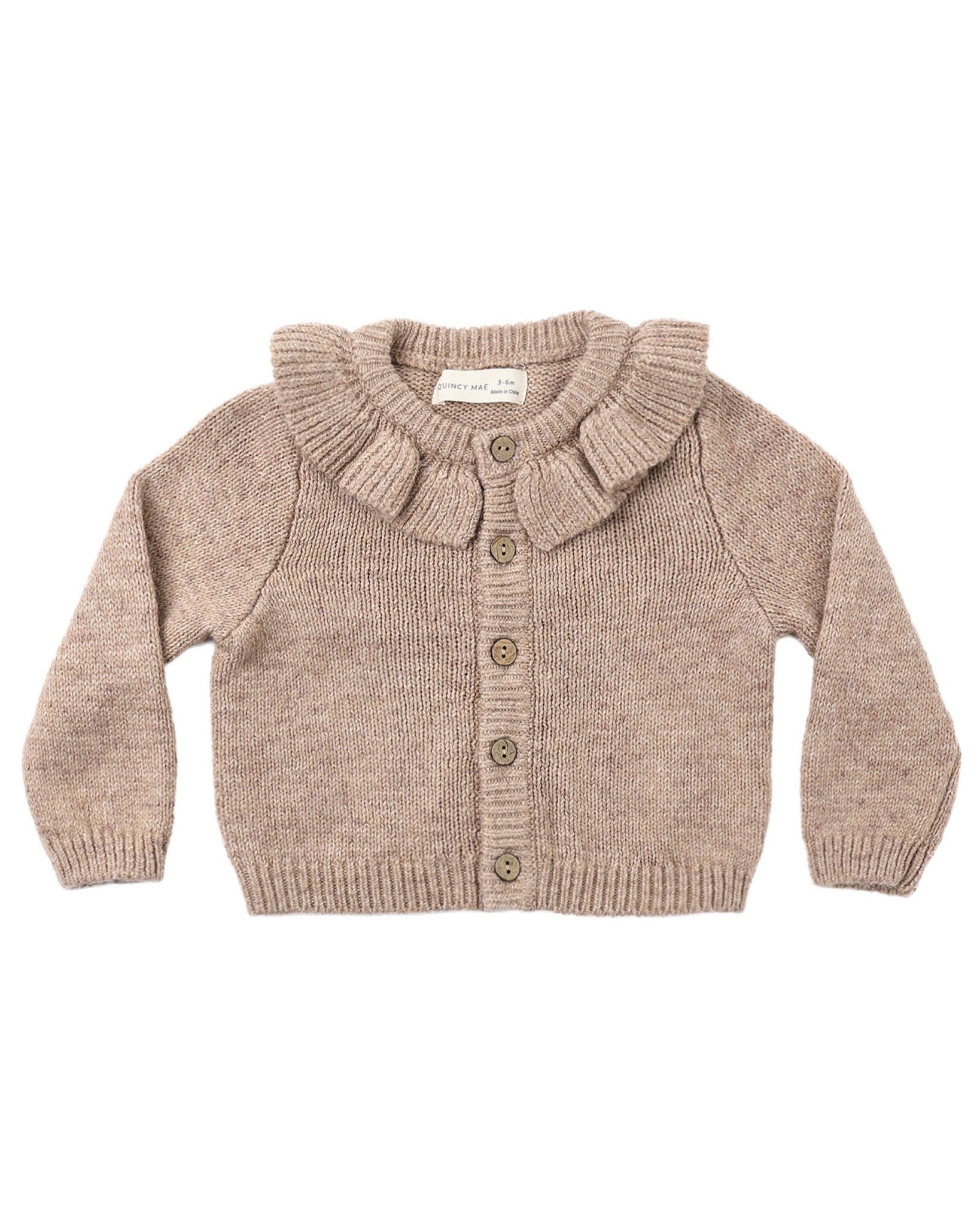 Knitted cardigan with ruffled collar on a white background