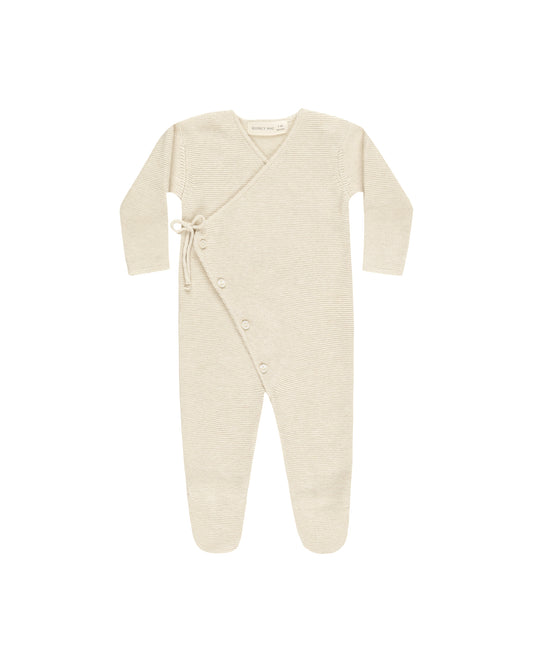 Beige baby onesie with buttons on a white background